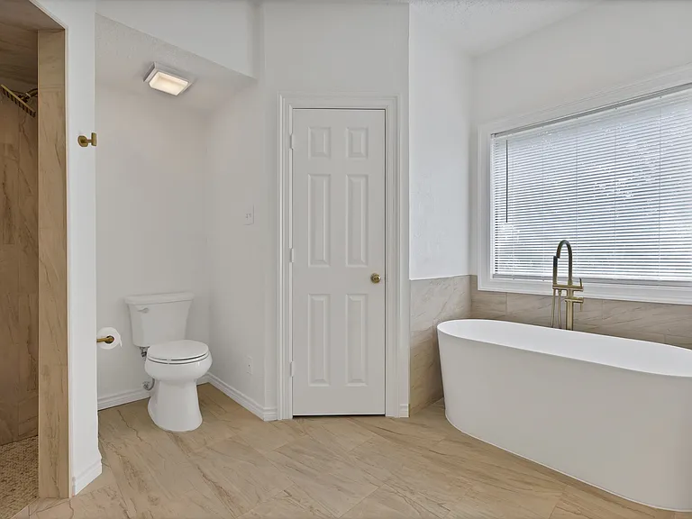 Primary Bathroom with separate tub and shower plus separate closets. Recently remodeled.