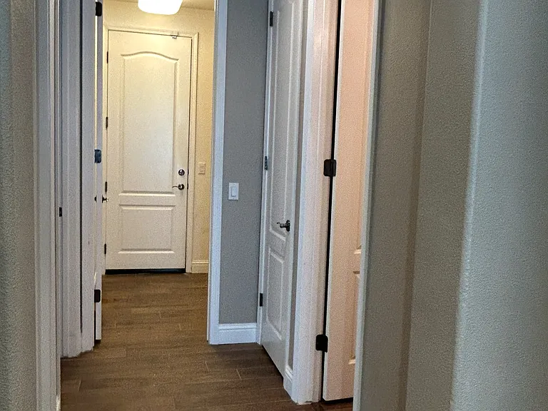 hallway to two other rooms, laundry room to the garage.