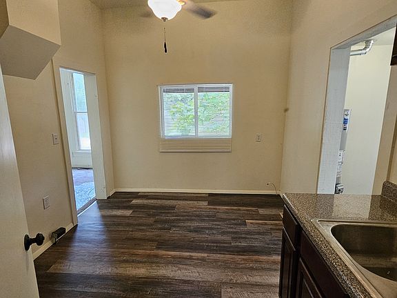 Large Kitchen with space for eating area on north wall. View is from doorway of bathroom. 2nd cupboard bank is to the left out of view. (Refrigerator and range not yet installed.)