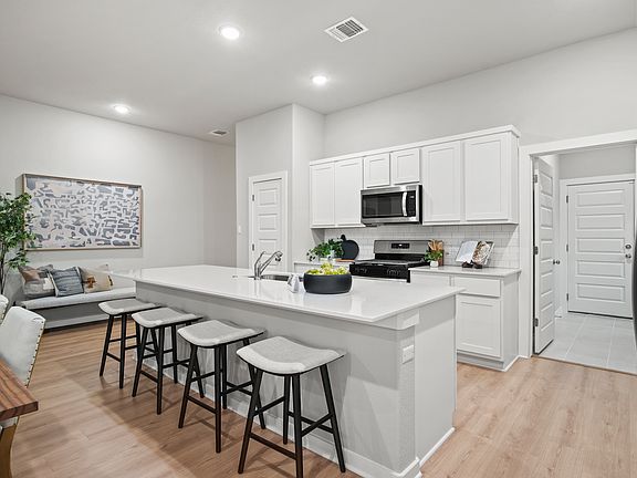 Kitchen in the Diamond home plan by Trophy Signature Homes - REPRESENTATIVE PHOTO
