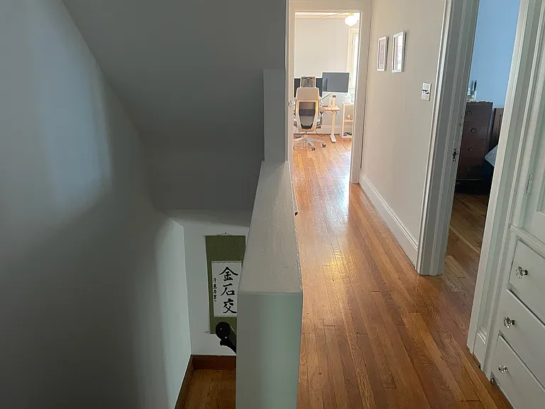 Hallway on in the second floor with stairs to the first floor on the left