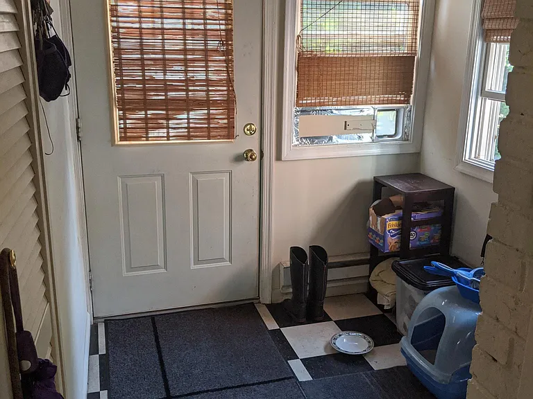 rear sun room leading to deck and parking