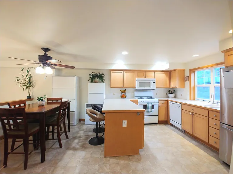 Sunny kitchen with breakfast bar and abundant storage