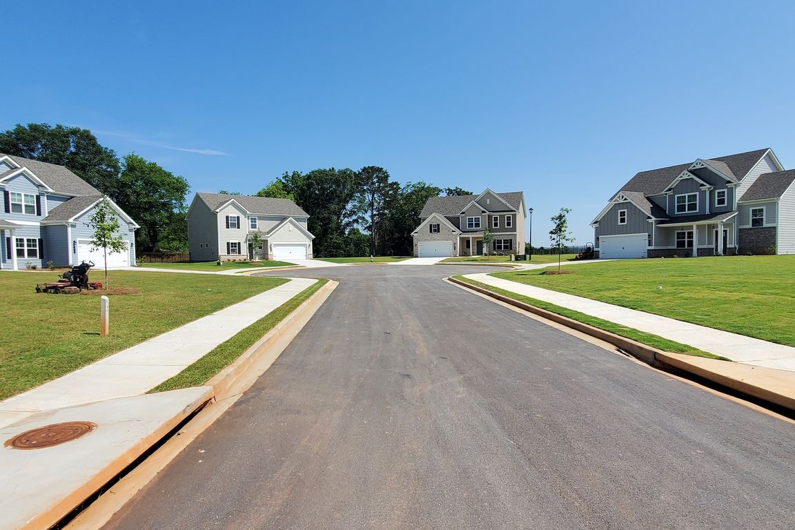 Southwind exterior: two-story homes with private driveways and attached garages on a cul-de-sac.
