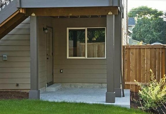 View of rear entry and patio from back yard