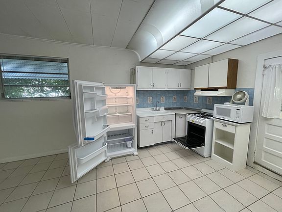 Kitchen with Gas stove (gas paid for by landlord), large fridge, microwave, plenty of storage