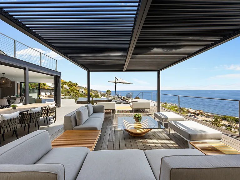 Lounge in the shade and unwind amidst the serene ambiance, surrounded by coastal breezes.