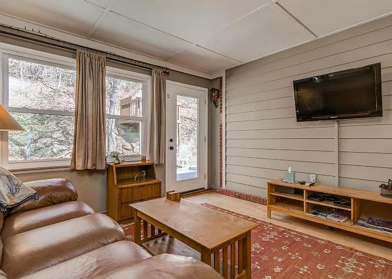 Comfy den with tv and leather sofa and chair