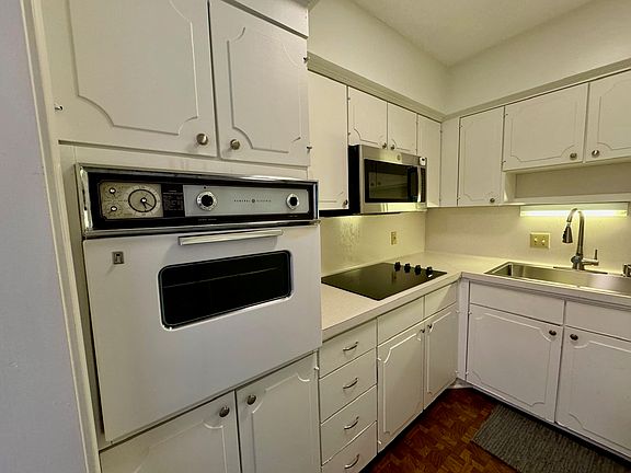 New microwave and electric cooktop. Wall oven is vintage, but works well!