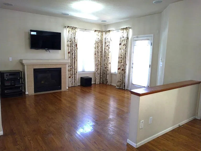 Family room with fireplace, surround system stays