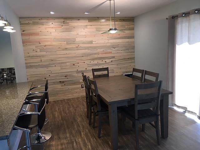 Dining room with blue stain beetle kill pine accent wall