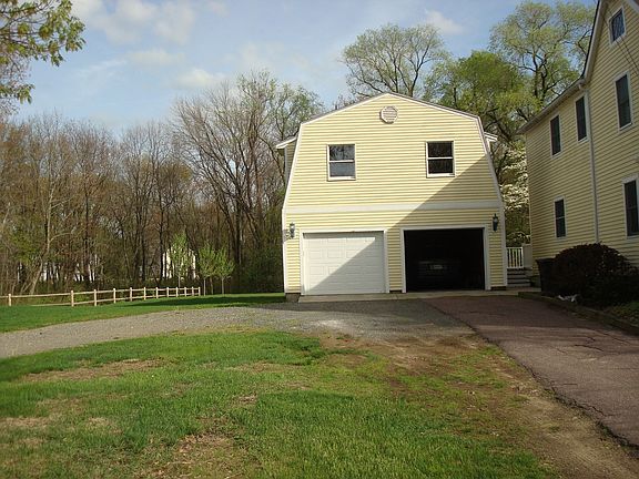 Large, two-car garage with unfinished upper room.
