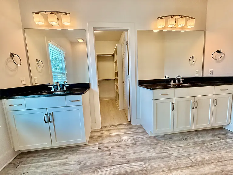 Two vanity areas that lead to the walk-in closet
