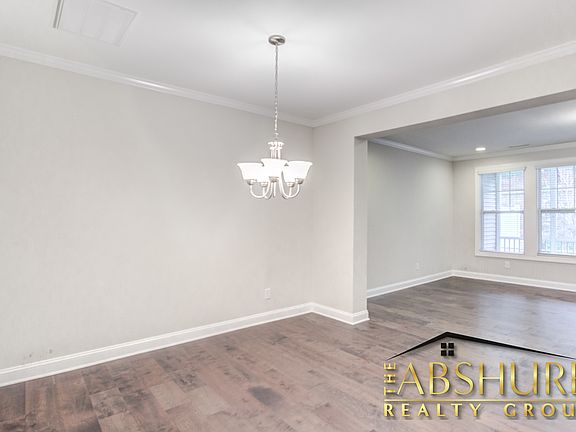 Open concept Dining Room with decorative crown molding