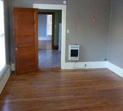 View into kitchen and living room from bedroom