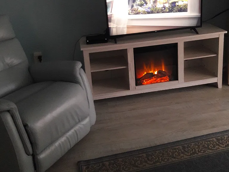 40 in flat screen TV with entertainment center. Fireplace turn on/off log glowing, heat generated fireplace with blower switch on/off for chilly nights, leather comfortable recliner on swivel.