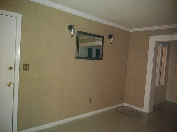 Front door and front room with beautiful wall sconces and mirror (adjacent to sunroom)