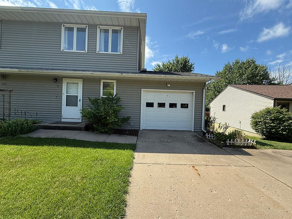 Welcoming front entrance with a wide driveway_fits two cars comfortably. Private attached garage with easy access