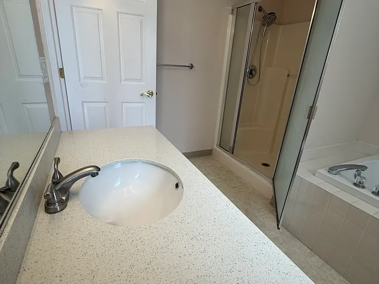 Master bath with separate shower and quartz counter top
