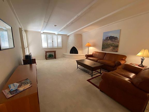 Large open living room with comfy leather seating and beehive fireplace