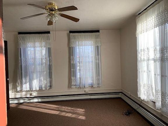 Living Room has several windows and ceiling fan