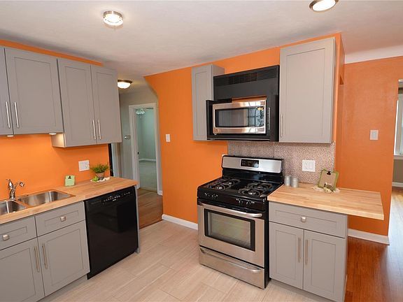 Kitchen new stove, micro wave,faucets and sink.