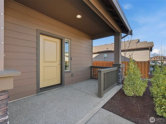 Covered front porch offering a warm and welcoming first impression.>