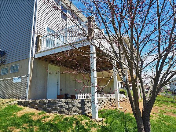Walk-out lower level with landscaped patio area, covered for more entertaining.