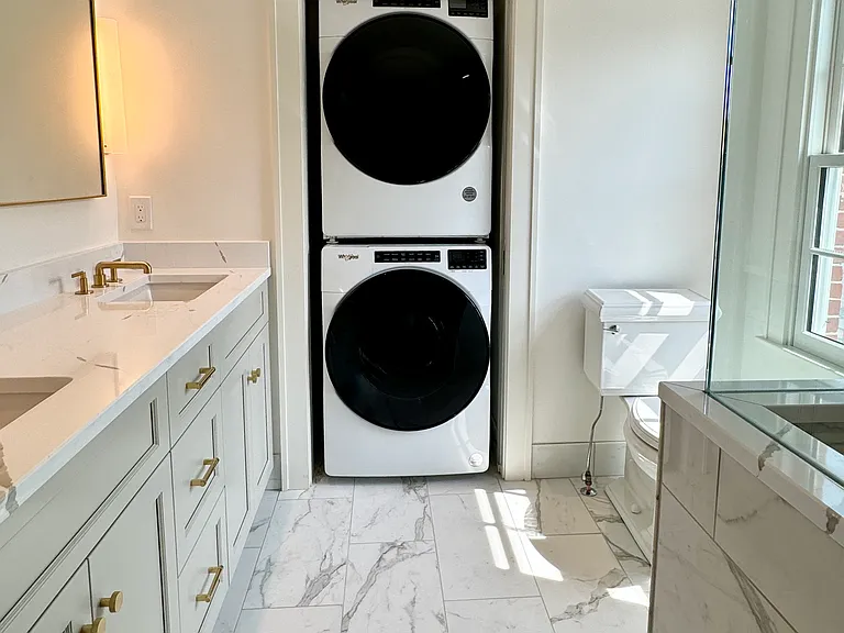 Master bathroom with walk-in shower and front-load washer/dryer