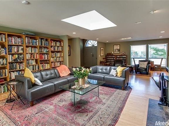 Open and spacious with dual pane windows and a skylight, this living room flows into the adjacent rooms.  Lots of recessed lighting adds to the charm...