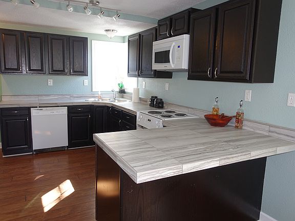 The kitchen island with space for bar stools.