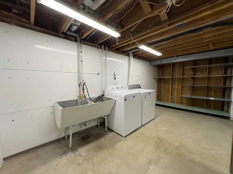 Laundry / utility room in basement. Additional storage