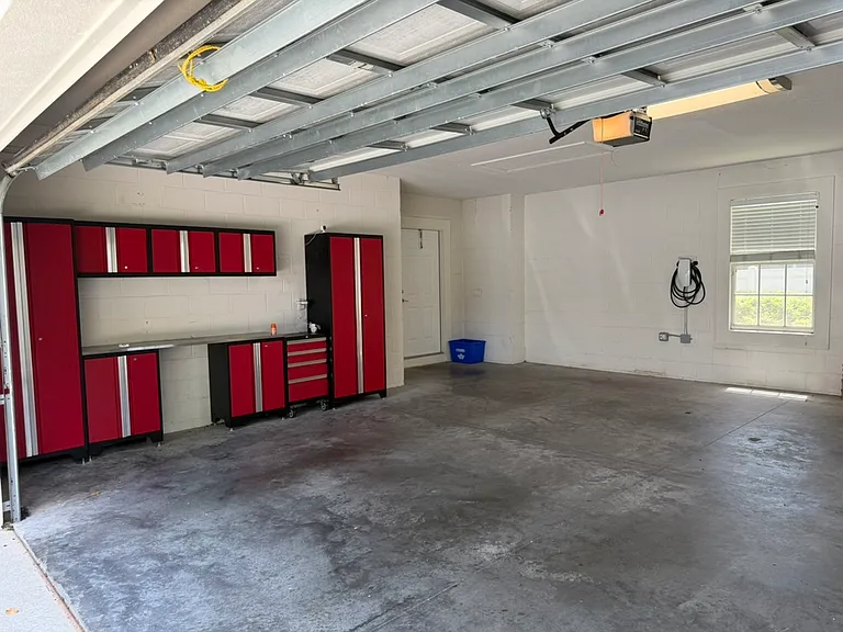 Garage tool storage showing door from the back porch and back door
