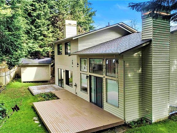 Side view of back yard showing off dual decks and large shed in the back