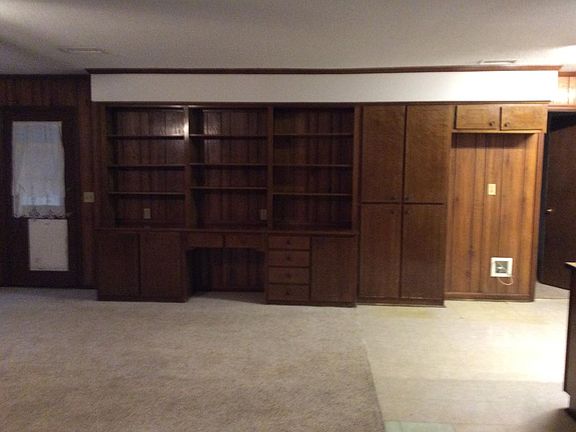 Den showing the bookcase and desk