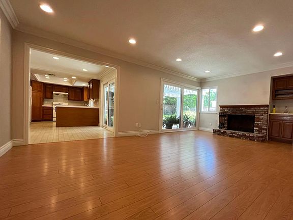 Family room with fireplace leading to the kitchen