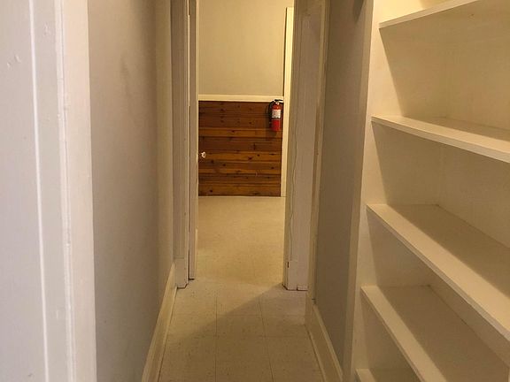 Hallway with built in shelving, bathrooom to right; looking towards kitchen.