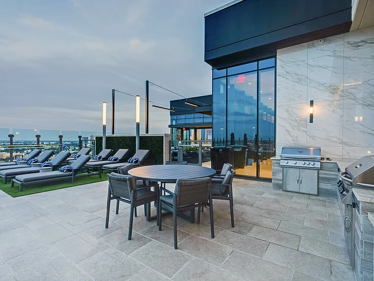 Rooftop lounge featuring grills and open-air dining