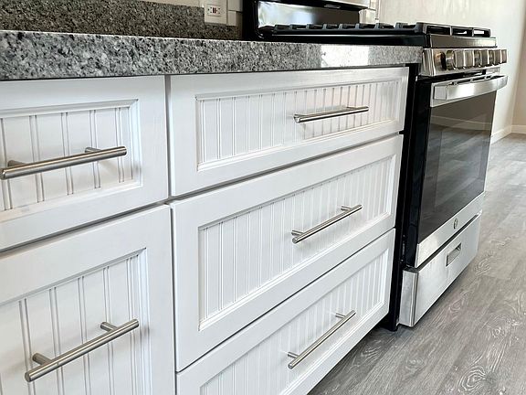 Large pull out drawers with soft close hardware, hidden trash drawer.