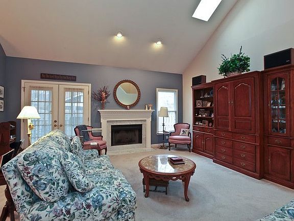 Cozy Great Room With Fireplace and French Doors to Screen Porch