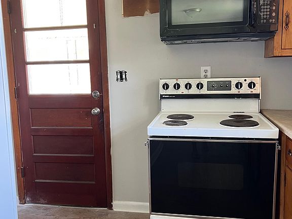 Kitchen with bedroom washer/dryer hookups to the left; entryway from carport