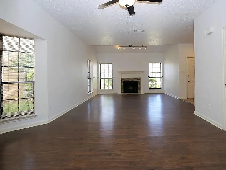 Main gathering room with wooden floor. Blinds installed (not in the pictures)