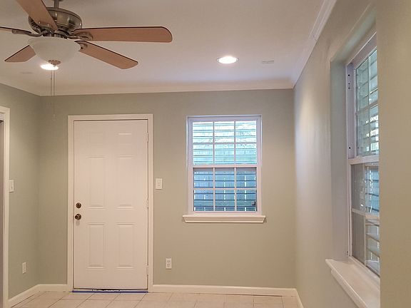 Spacious bedroom with back door facing fence and quiet rear