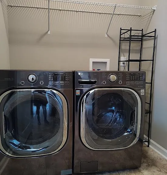 The laundry room is located between the kitchen and the garage.