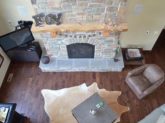 Great room with gas fireplace and surround sound, as seen from upstairs den with balcony open to great room.