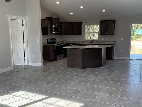 View of living room and kitchen from front door
