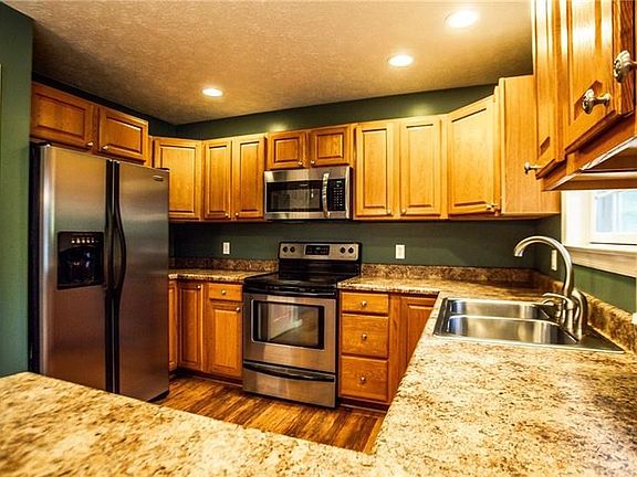 Spacious kitchen with stainless appliances.