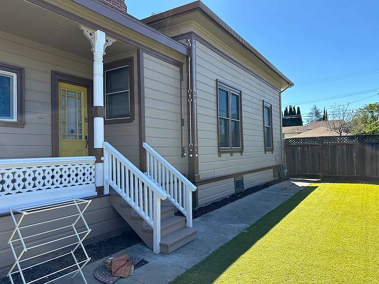 Side yard and alternate side entry into kitchen with high fence