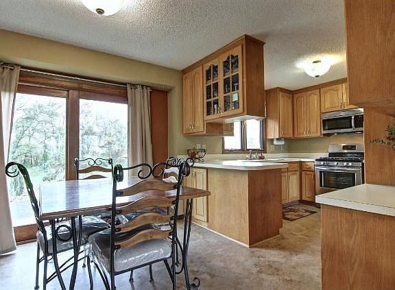 This dining room has a sliding glass door that leads you onto your large patio area with fire pit which is perfect for entertaining friends and family!