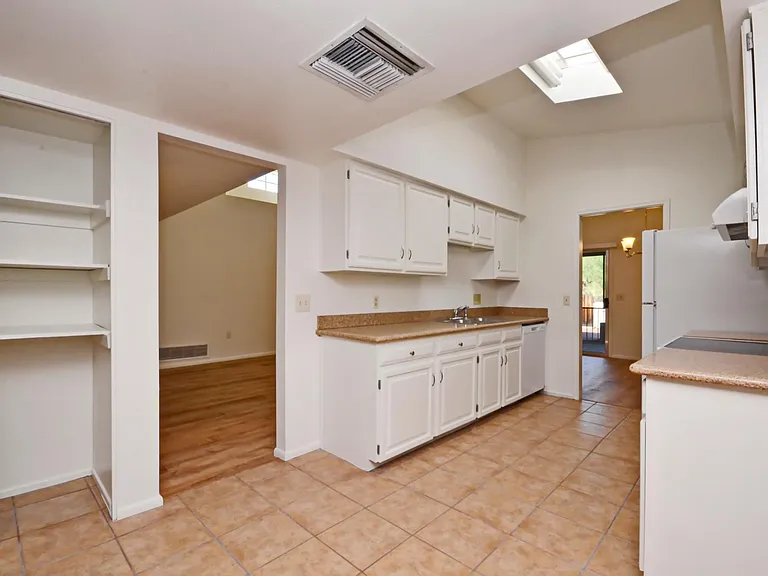 Light and bright galley eat-in kitchen with granite counter tops, new appliances and pantry.